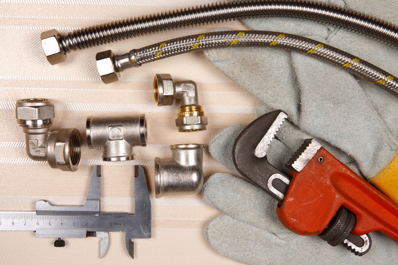 Plumber working on pipes in a Fulham home